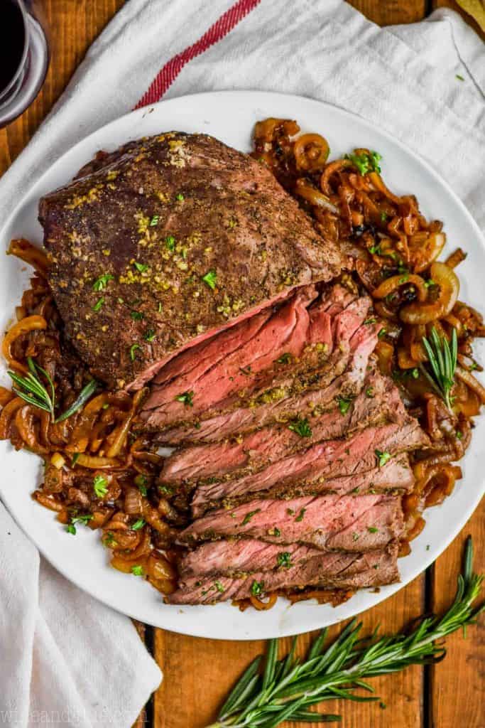 A picture showing fully cooked roast beef dished on a white, ceramic, serving plate